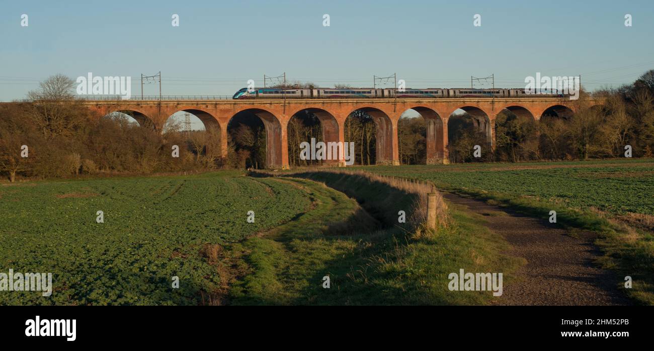 Trans Pennine train crossing viaduct over farmland on an Autumn afternoon in County Durham Stock Photo