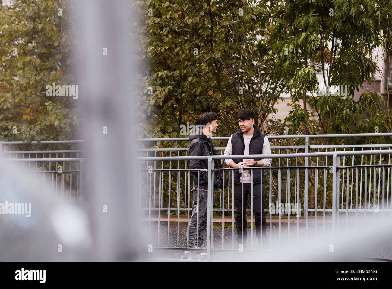 Male friends talking together Stock Photo