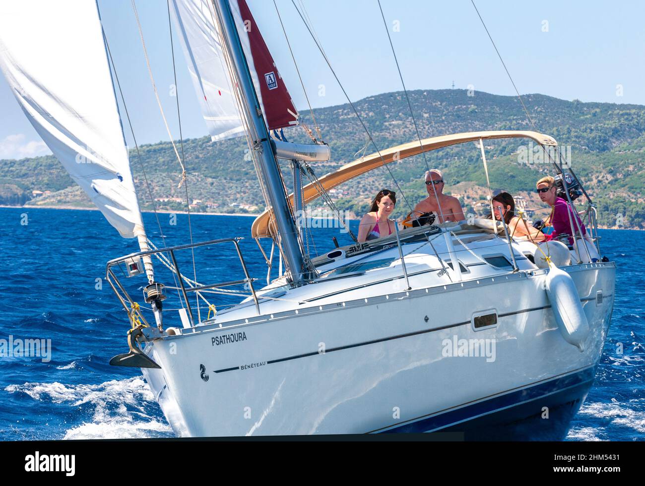 Family on sailing holiday in mid-summer off the Greek island of Alonnisos in the Aegean sea, Greece, Europe Stock Photo