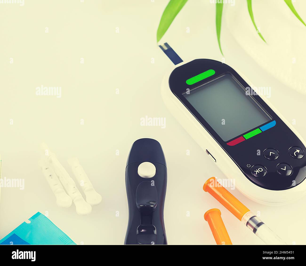 Diabetes control. Diabetic disease concept with Glucose meter, test strips for determining blood sugar levels, lancets and insulin syringes on a white Stock Photo