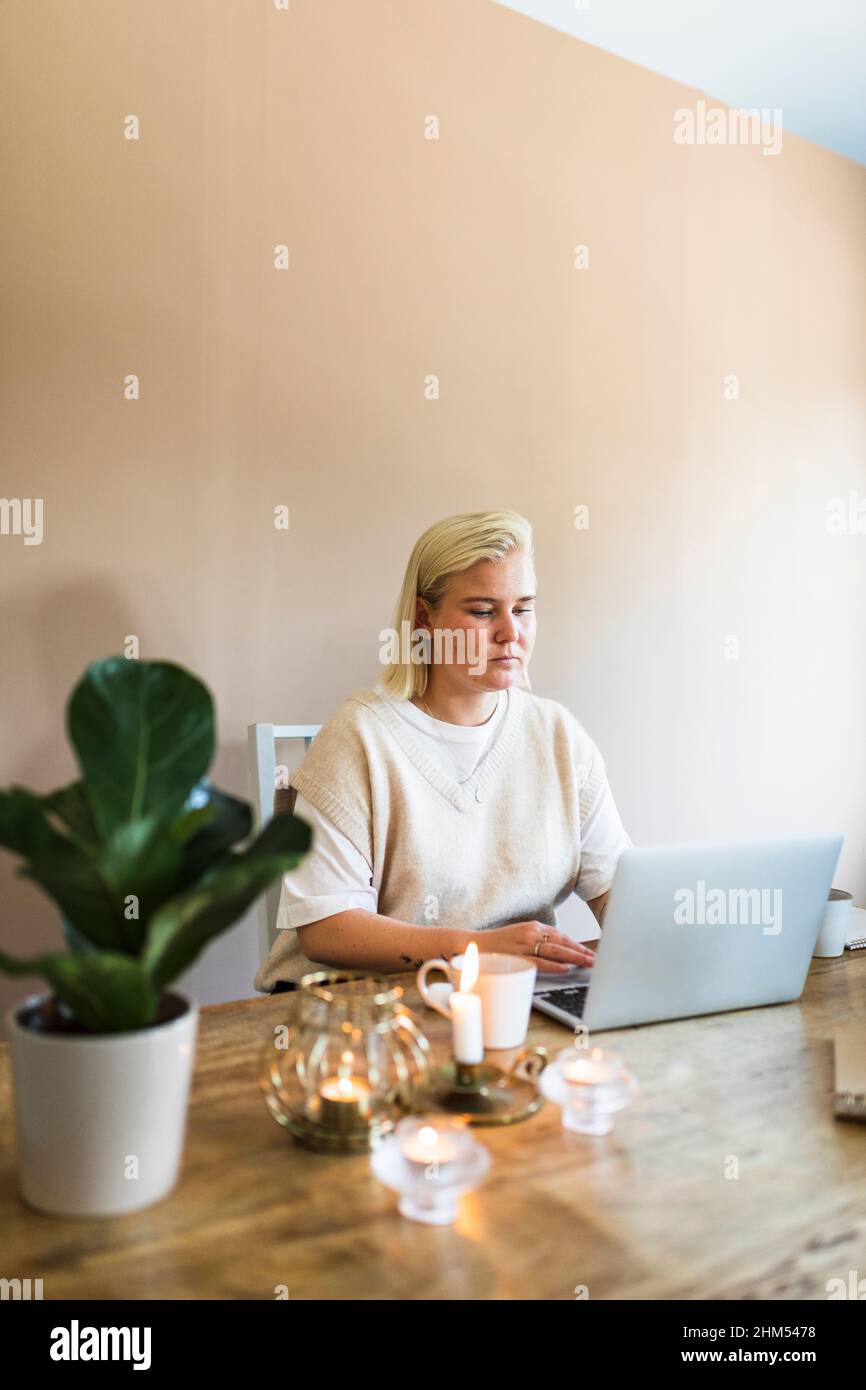Woman using laptop at home Stock Photo