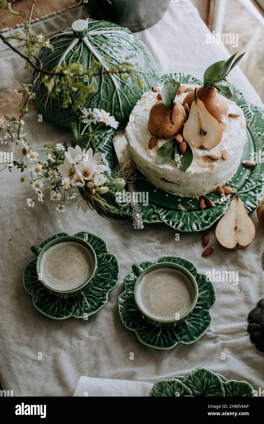 Pear cake and coffee cups on table Stock Photo