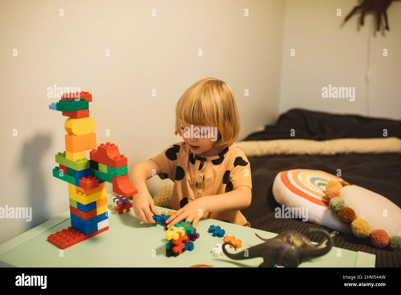 Girl playing with toy blocks Stock Photo