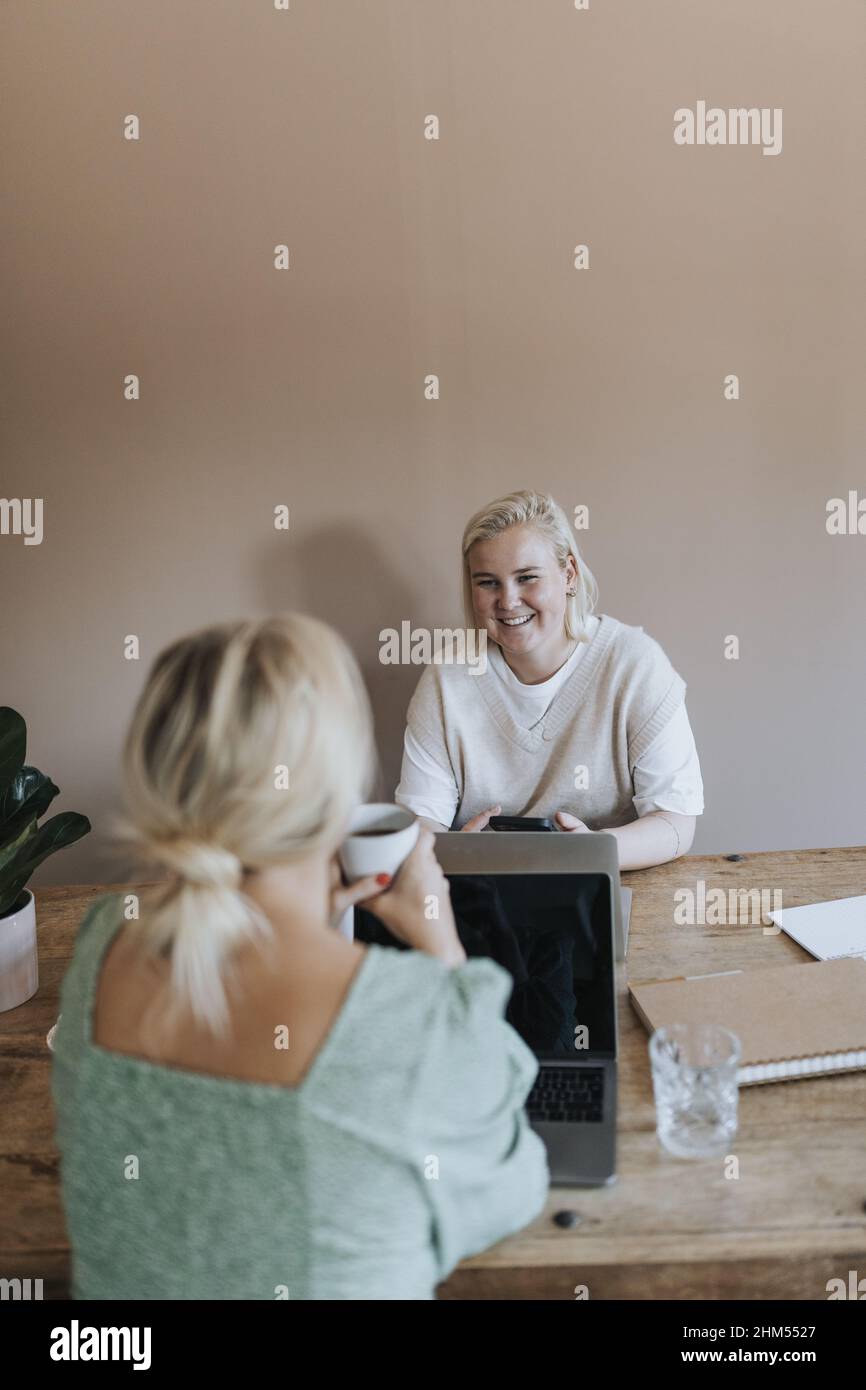 Coworkers talking to each other Stock Photo