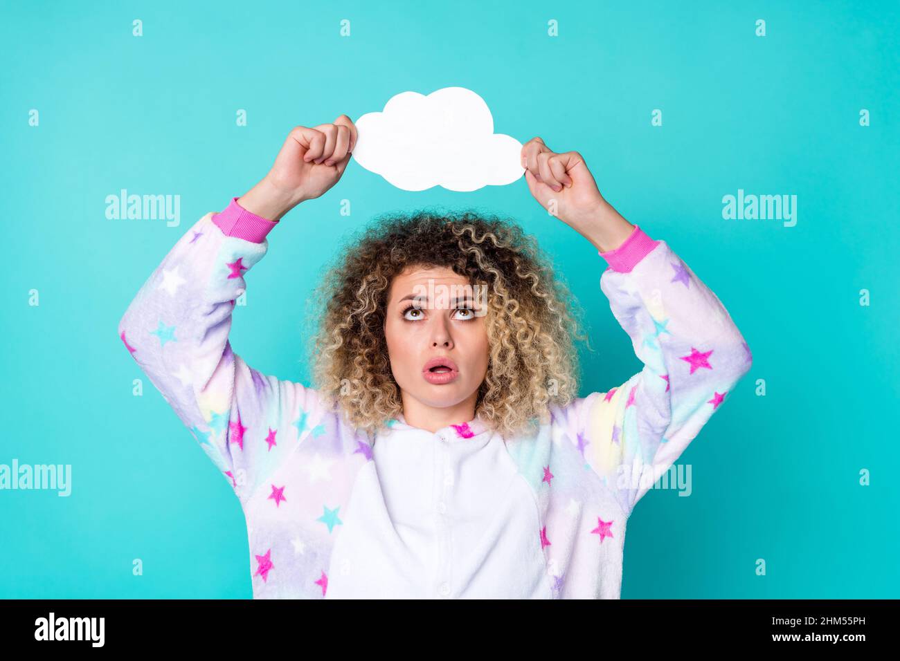 Portrait of attractive worried wavy-haired girl holding copy space bubble advert ad isolated over bright teal turquoise color background Stock Photo