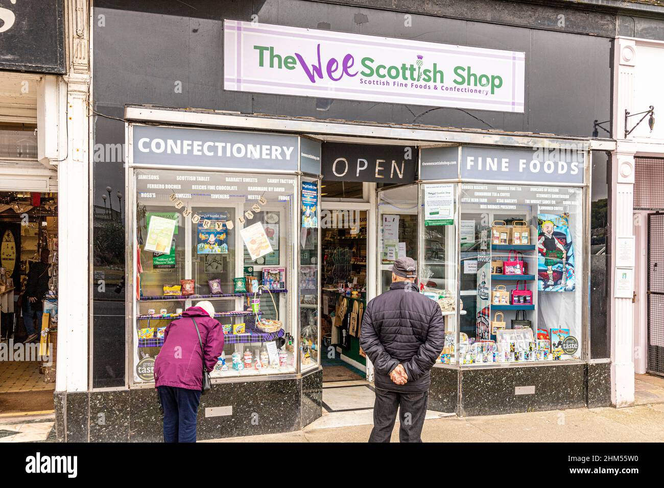 Customers perusing The Wee Scottish Shop in Victoria Street, Rothesay on the Isle of Bute, Argyll & Bute, Scotland UK Stock Photo