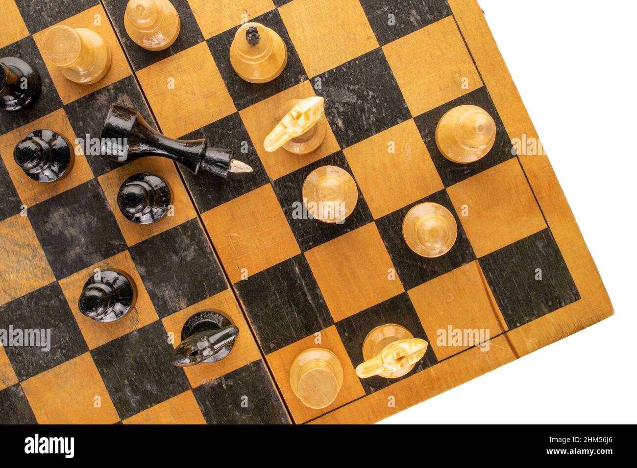 Old wooden chess pieces on a chessboard, macro, top view. Stock Photo