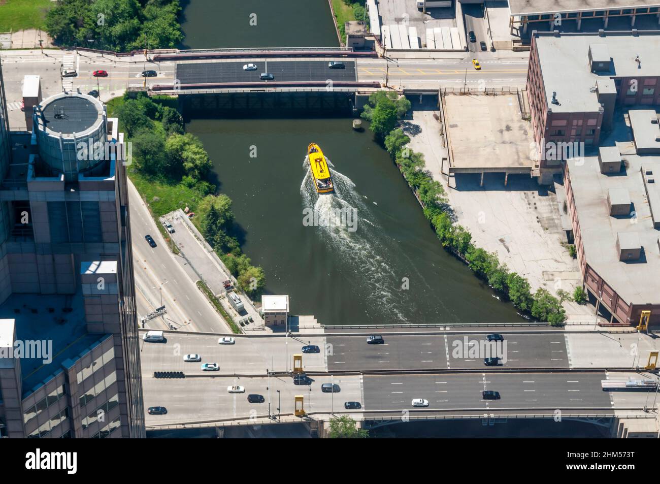 Aerial view of yellow water taxi on southern branch of the Chicago River between the bridges of the Dwight D Eisenhower Expressway & West Harrison St. Stock Photo