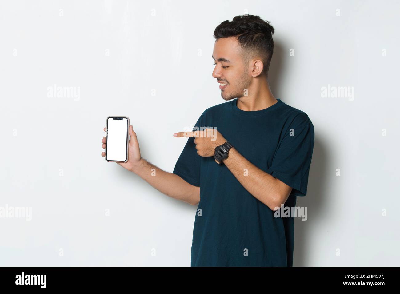 young man demonstrating mobile cell phone on white background Stock Photo