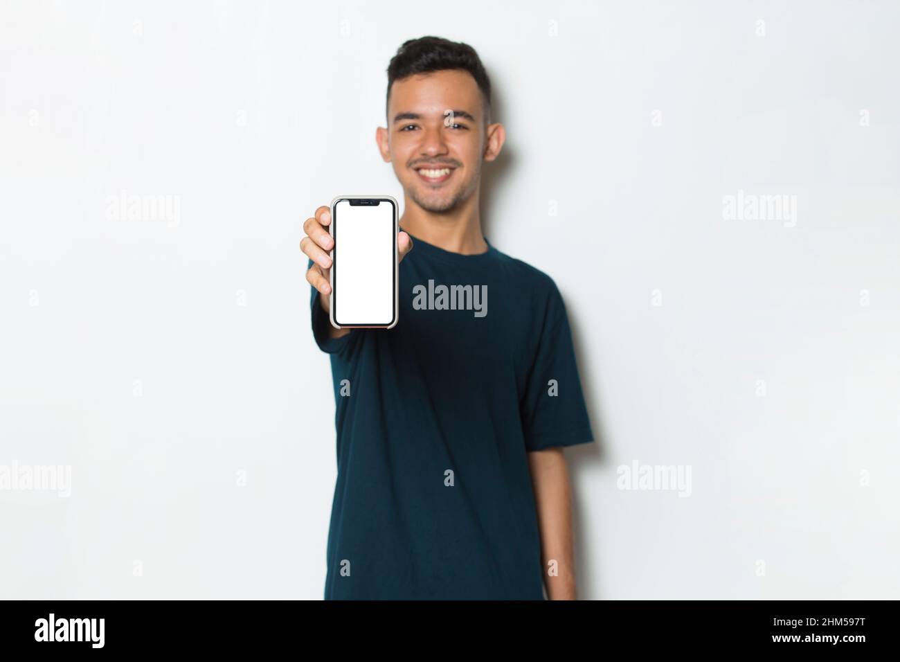 young man demonstrating mobile cell phone on white background Stock Photo