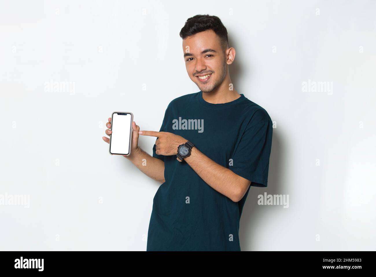 young man demonstrating mobile cell phone on white background Stock Photo