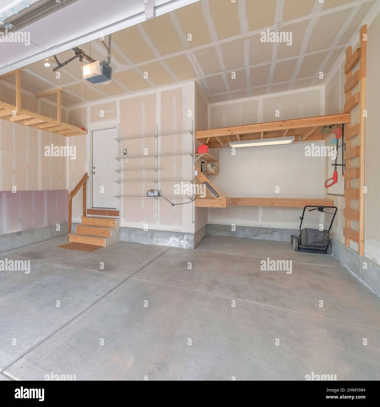 Square Interior of an unfinished garage with wooden shelving units and ...