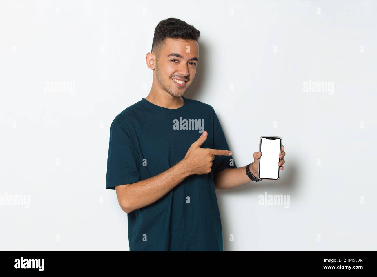 young man demonstrating mobile cell phone on white background Stock Photo