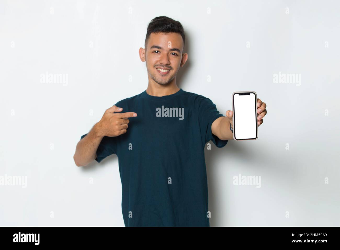 young man demonstrating mobile cell phone on white background Stock Photo