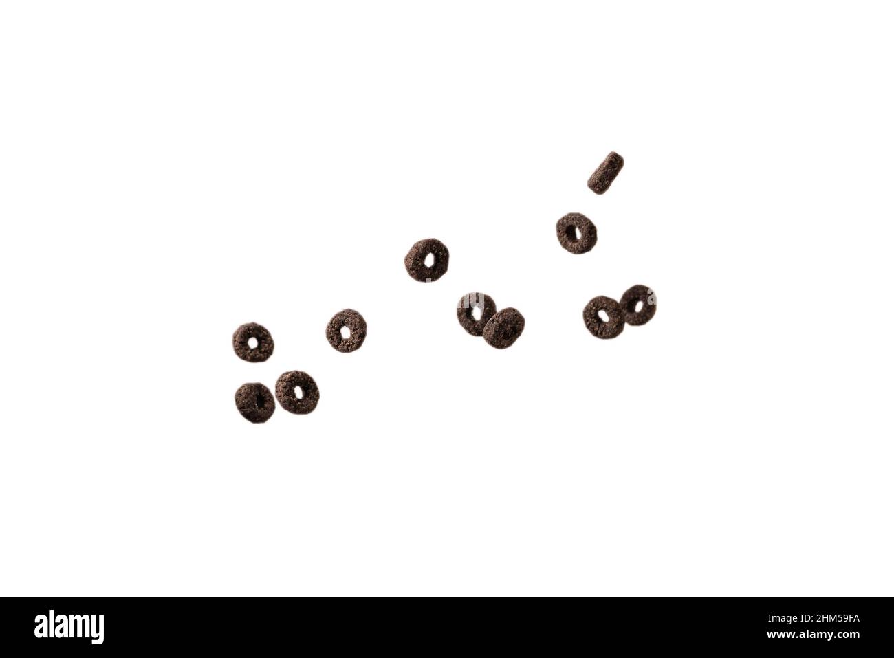 Chocolate rings cereal spill out into a bowl. Breakfast. Isolated on a