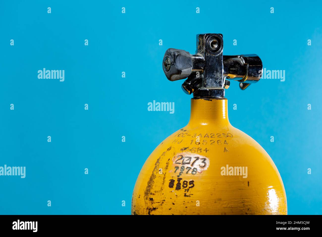 Vintage yellow steel scuba tank with hydrostatic test dates Stock Photo