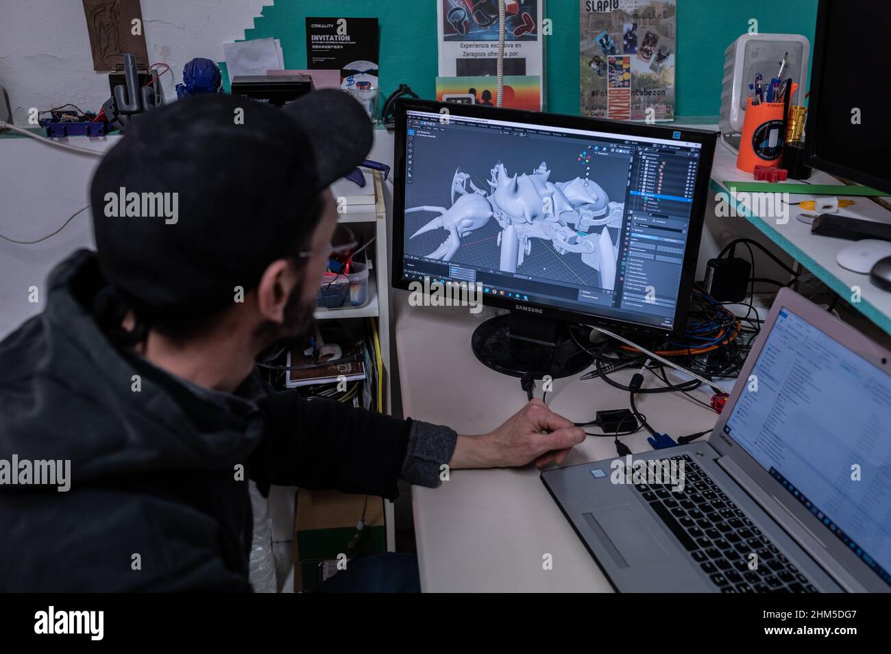 Chuan works on a 3D printed robot design at Zaragoza MakerSpace, a non-profit association that aims to serve as a platform to learn and develop projec Stock Photo