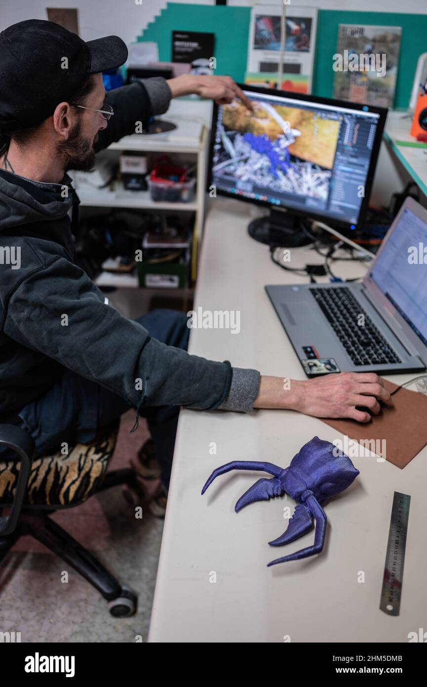 Chuan works on a 3D printed robot design at Zaragoza MakerSpace, a non-profit association that aims to serve as a platform to learn and develop projec Stock Photo