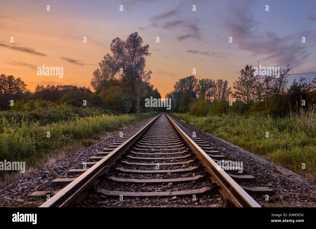 Railroad tracks and beautiful sky at sunset Stock Photo