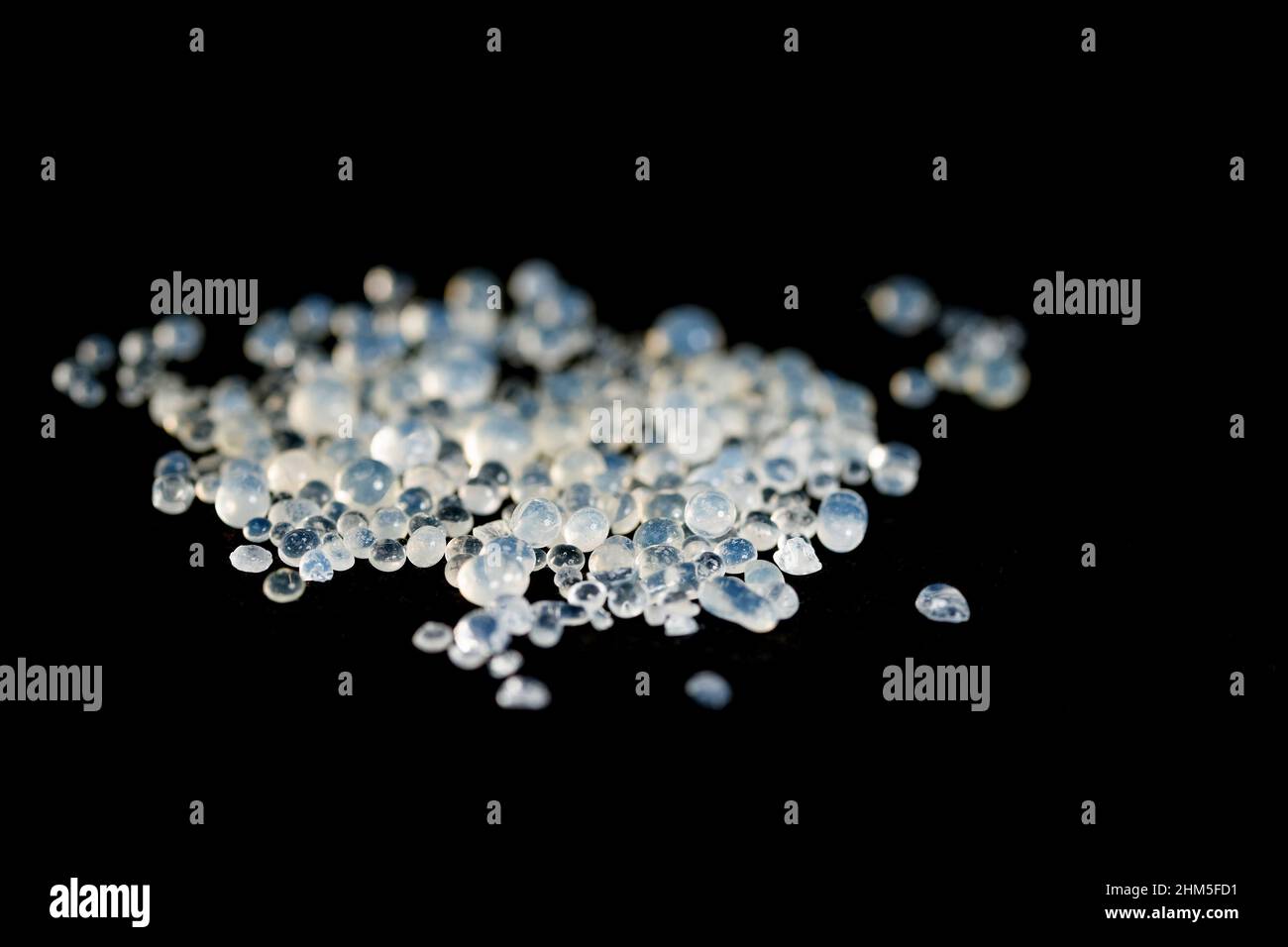 Silica gel, desiccant beads against a black background Stock Photo Alamy