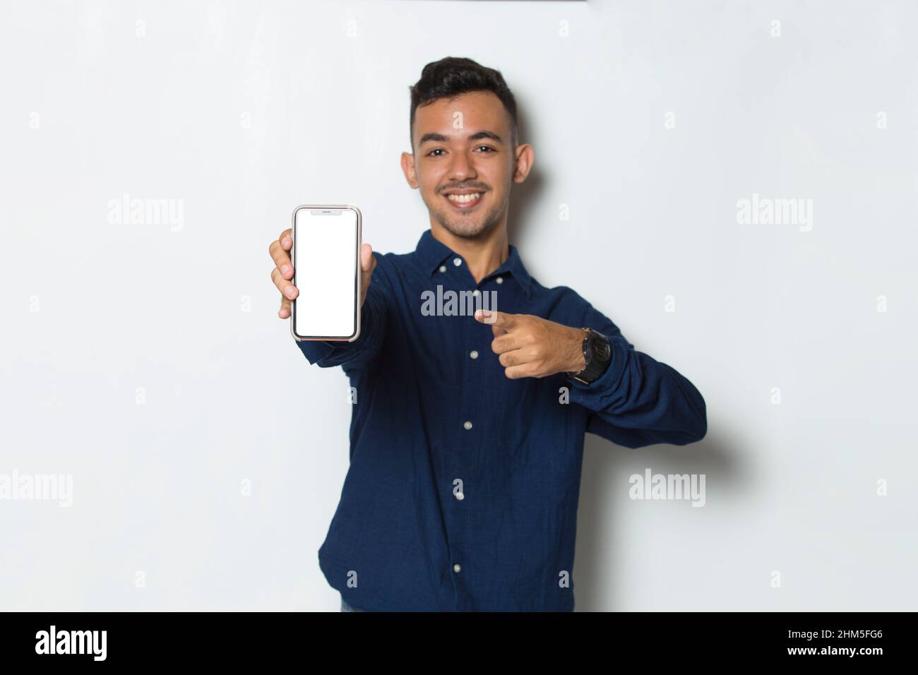 young man demonstrating mobile cell phone on white background Stock Photo