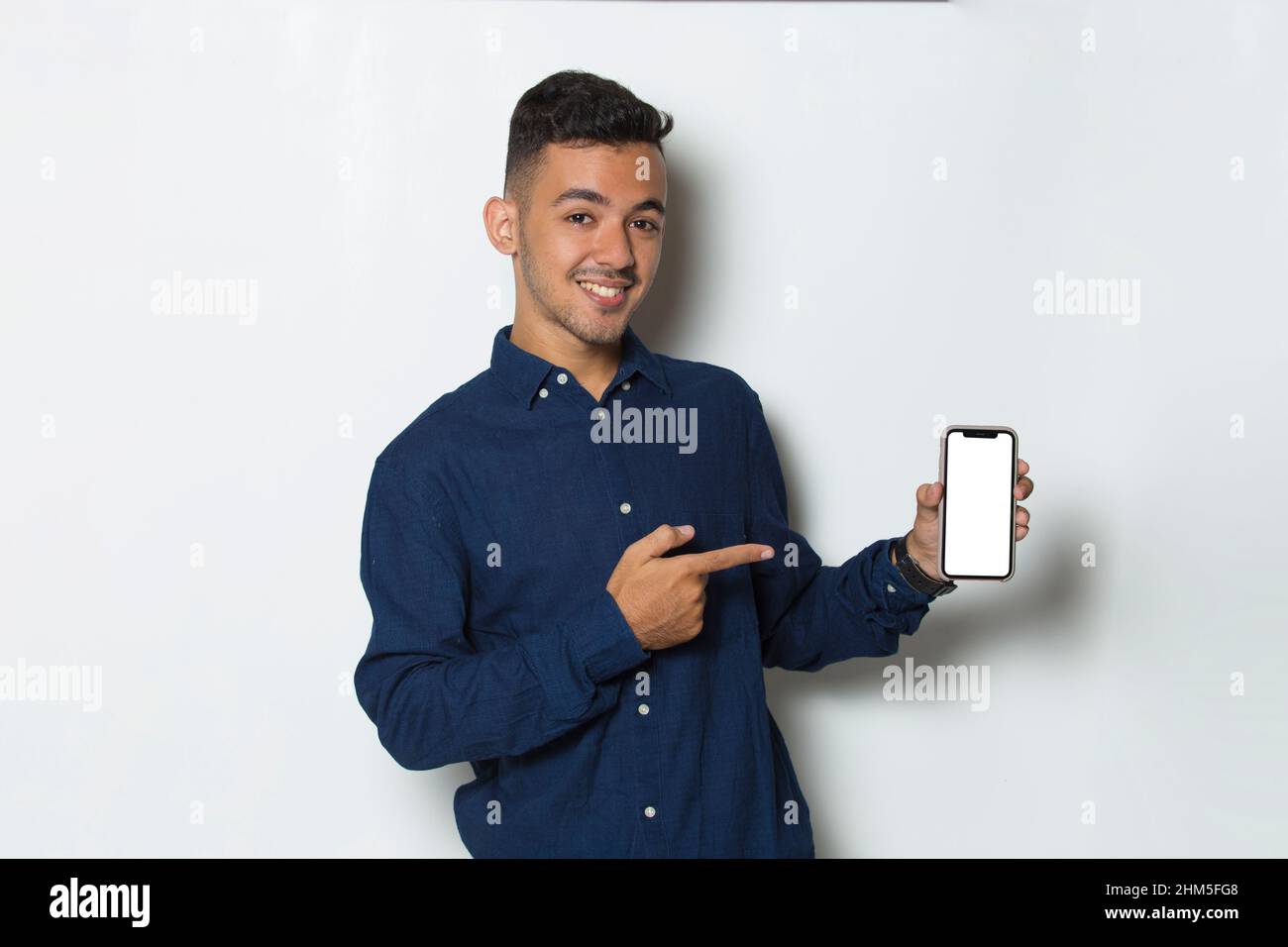 young man demonstrating mobile cell phone on white background Stock Photo