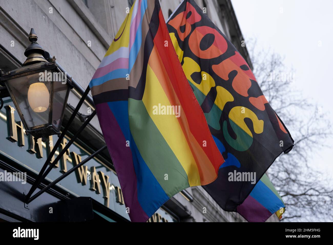 Intersex Progress Pride flags outside a pub in on 22nd January 2022 in London, United Kingdom. The flag includes stripes to represent LGBTQ+ communities, with colors from the Transgender Pride Flag, alongside the and circle of the Intersex flag. Stock Photo