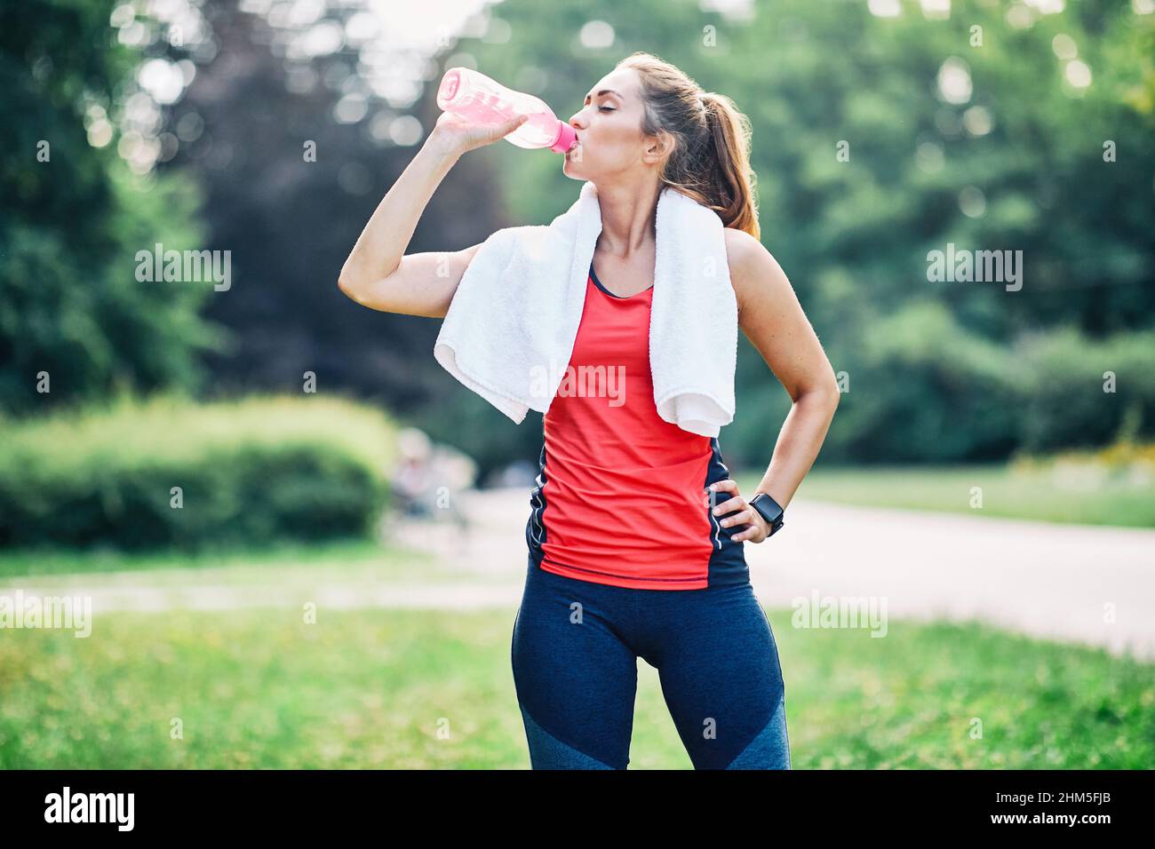 fitness woman park exercise lifestyle outdoor sport healthy female nature active young water drinking Stock Photo
