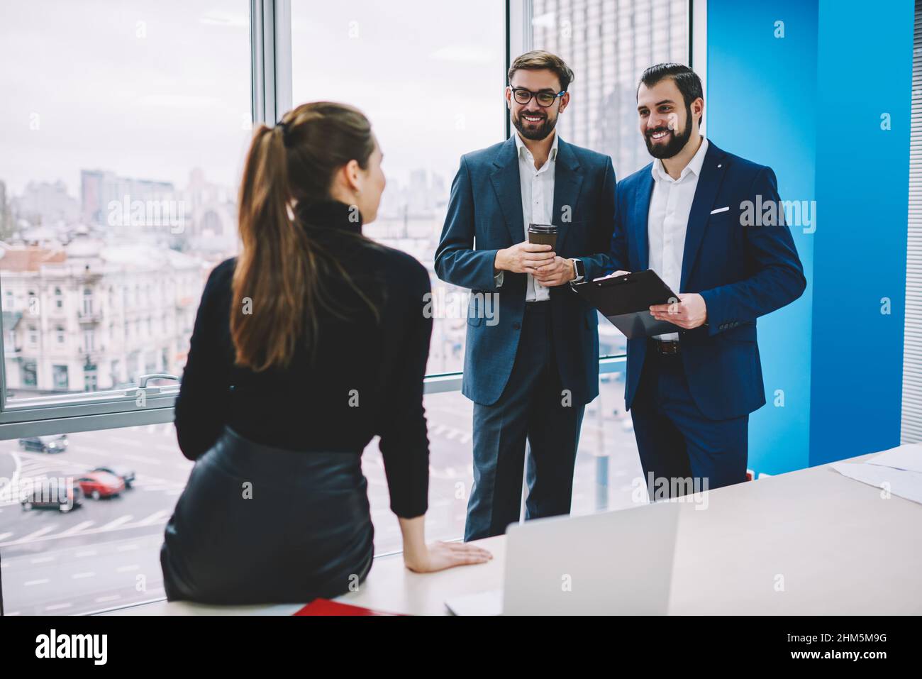 Friendly colleagues having conversation in modern office Stock Photo