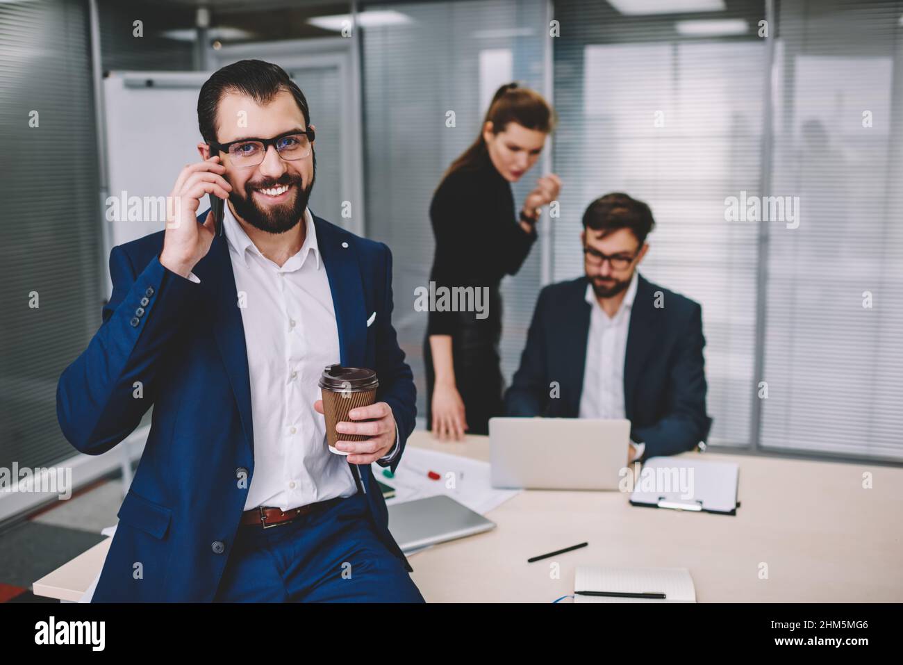 Happy bearded man talking on phone Stock Photo