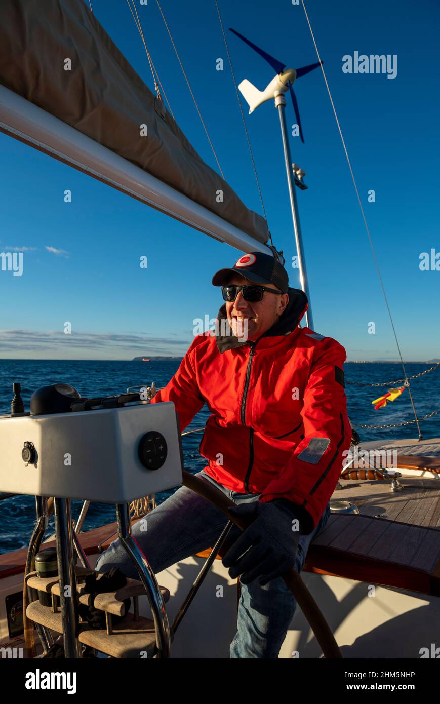 Young man steering boat hi-res stock photography and images - Alamy