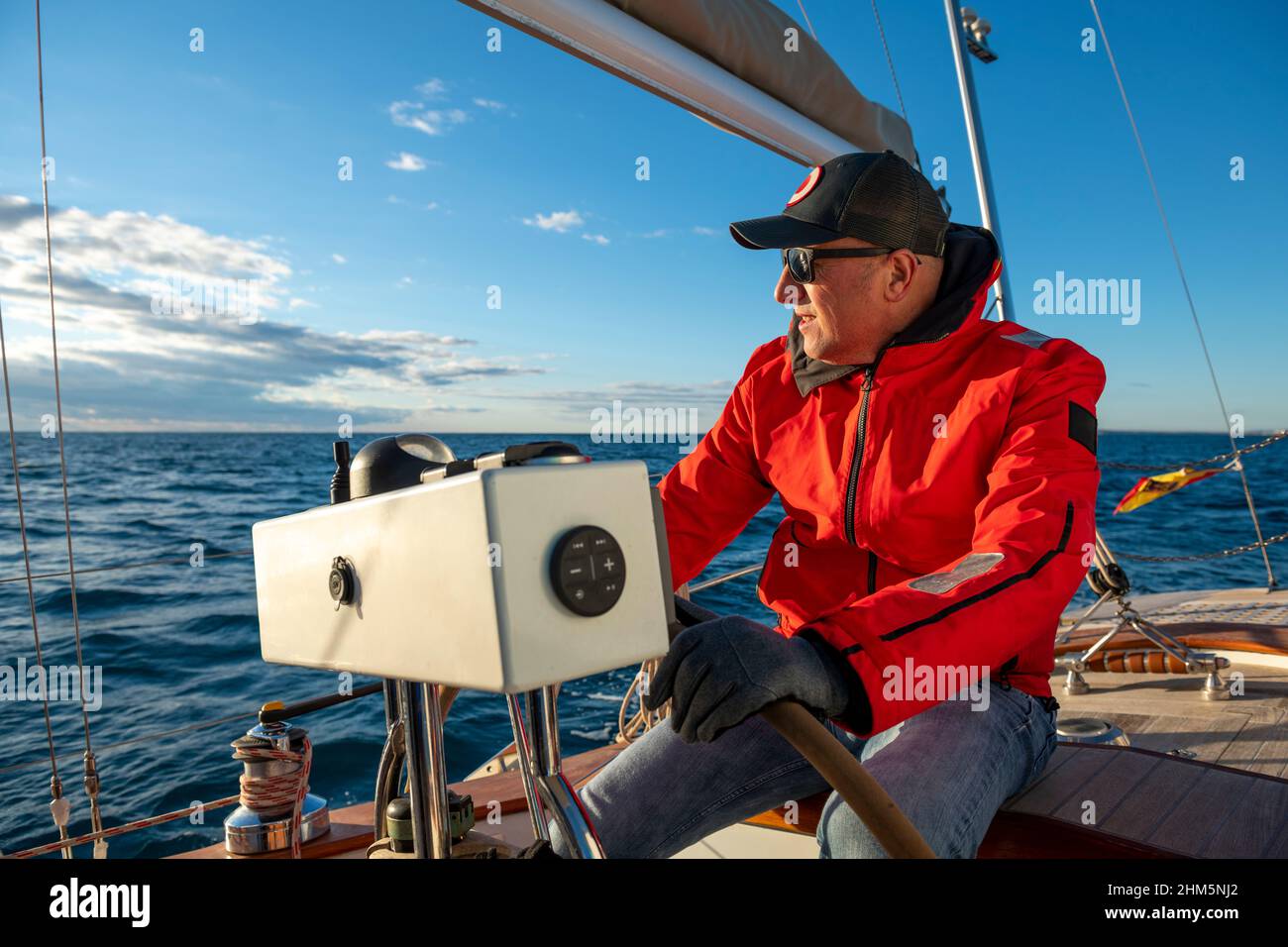Young man steering boat hi-res stock photography and images - Alamy