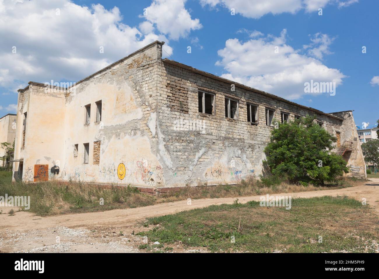 Uyutnoye village, Saksky district, Crimea, Russia - July 18, 2021: A crumbling building on Kirov street in the village of Uyutnoye, Saksky district, C Stock Photo