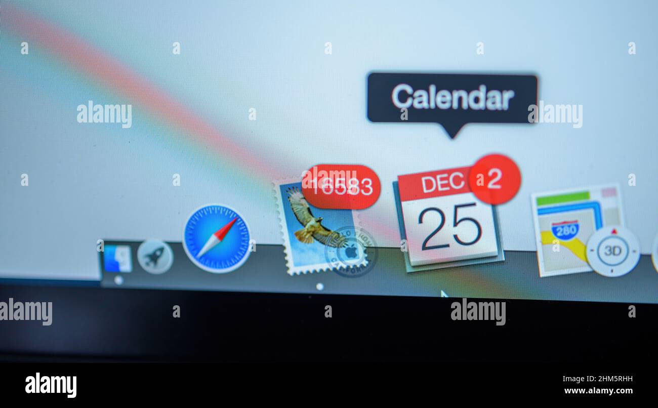 London, United Kingdom - Dec 25, 2018: Tilt-shift lens focus on the Mail app with 16583 unread message sn and Calendar with two appointmens icons in the dock bar of the Apple Computers MacBook Pro laptop Stock Photo