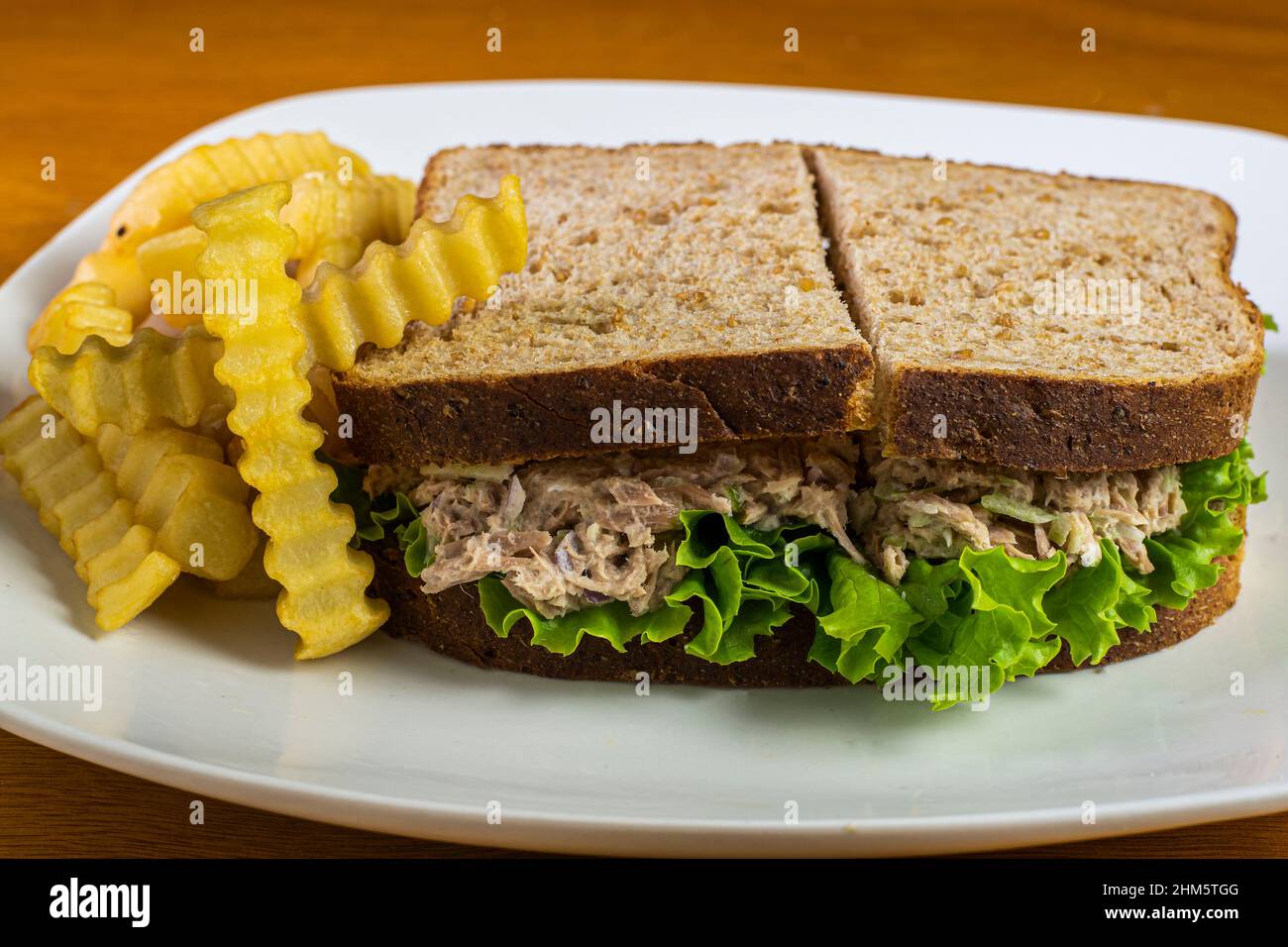 tuna fish on wheat bread and served with a side of fries Stock Photo