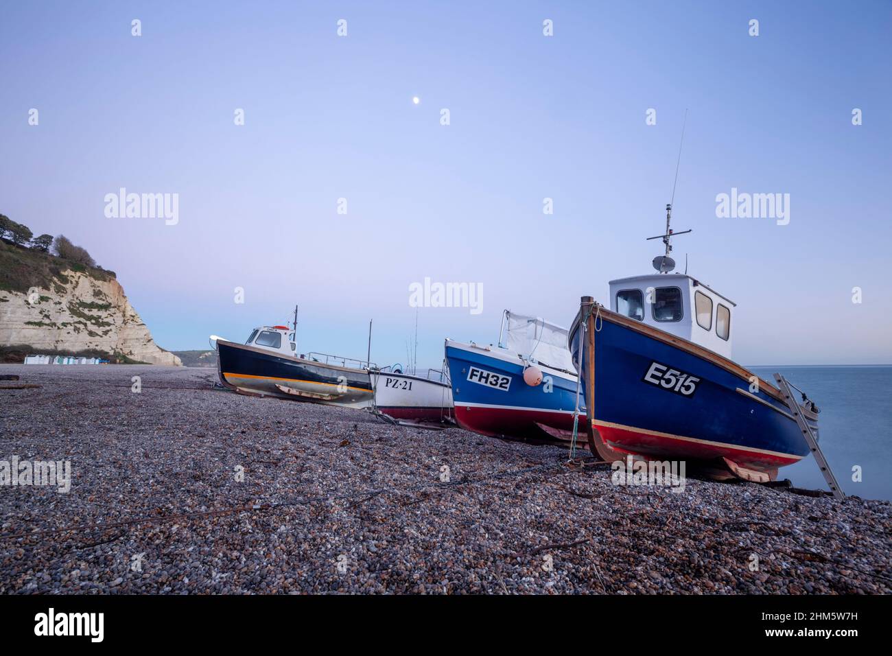 Fishing boats hauled up on Beer Beach. Jurassic Coast World Heritage Site. Devon, UK. Stock Photo
