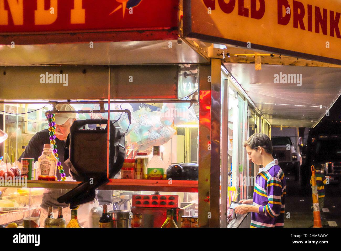NEW ORLEANS, LA, USA - FEBRUARY 24, 2017: Paradegoer ordering concessions at a food truck along the Mardi Gras parade route in New Orleans Stock Photo