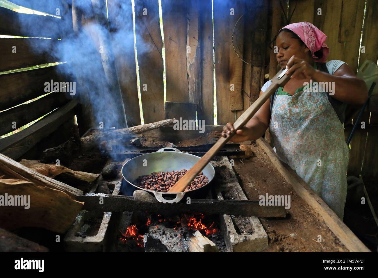 Woman roasting cacao beans on an open fire. Talamanca, South Caribbean