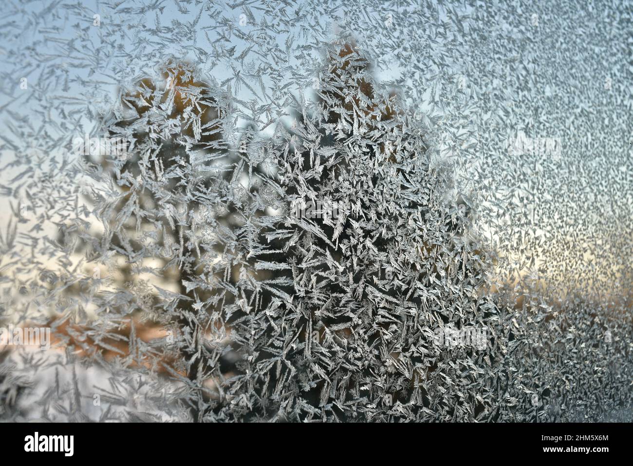 Ice cold frost crystals pattern on glass window of home in countryside ...