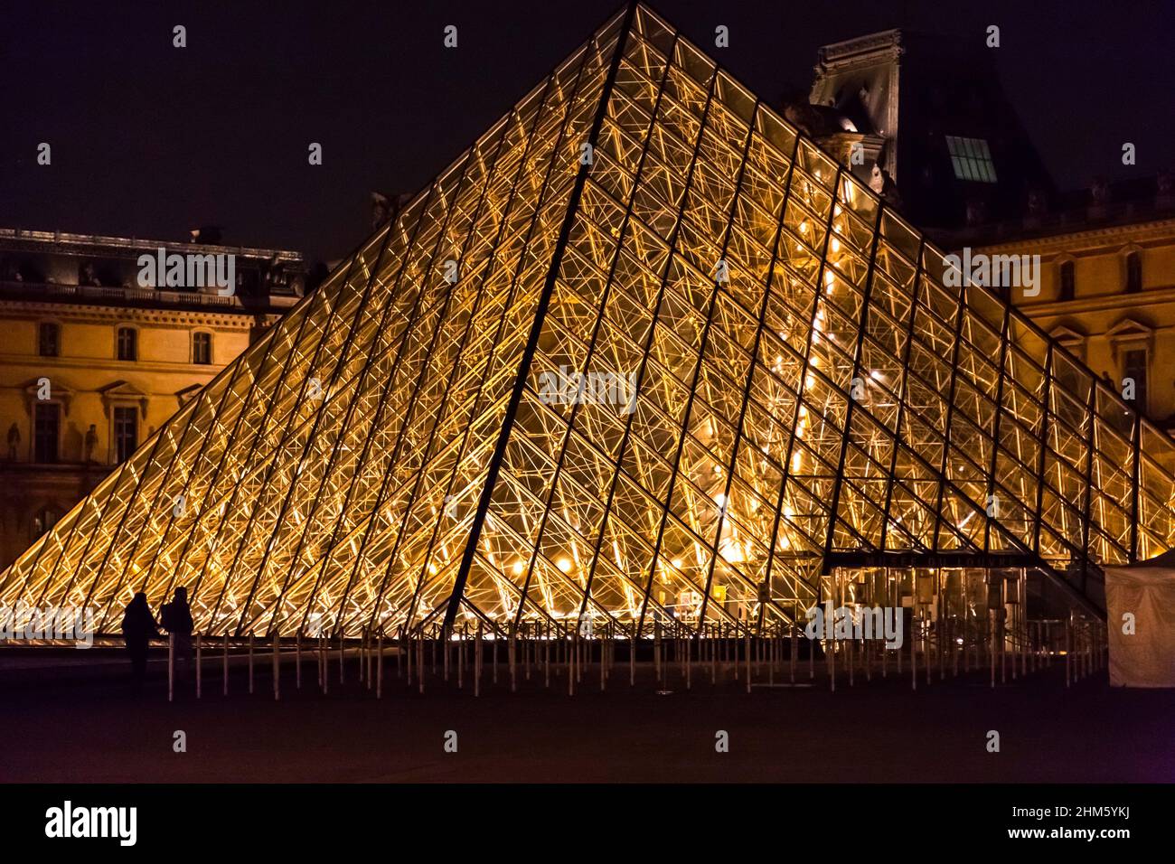 Paris, France - JAN 24, 2022: The glass pyramid of Louvre Museum, the main entrance to famous museum and gallery, completed in 1989. A beautiful winte Stock Photo