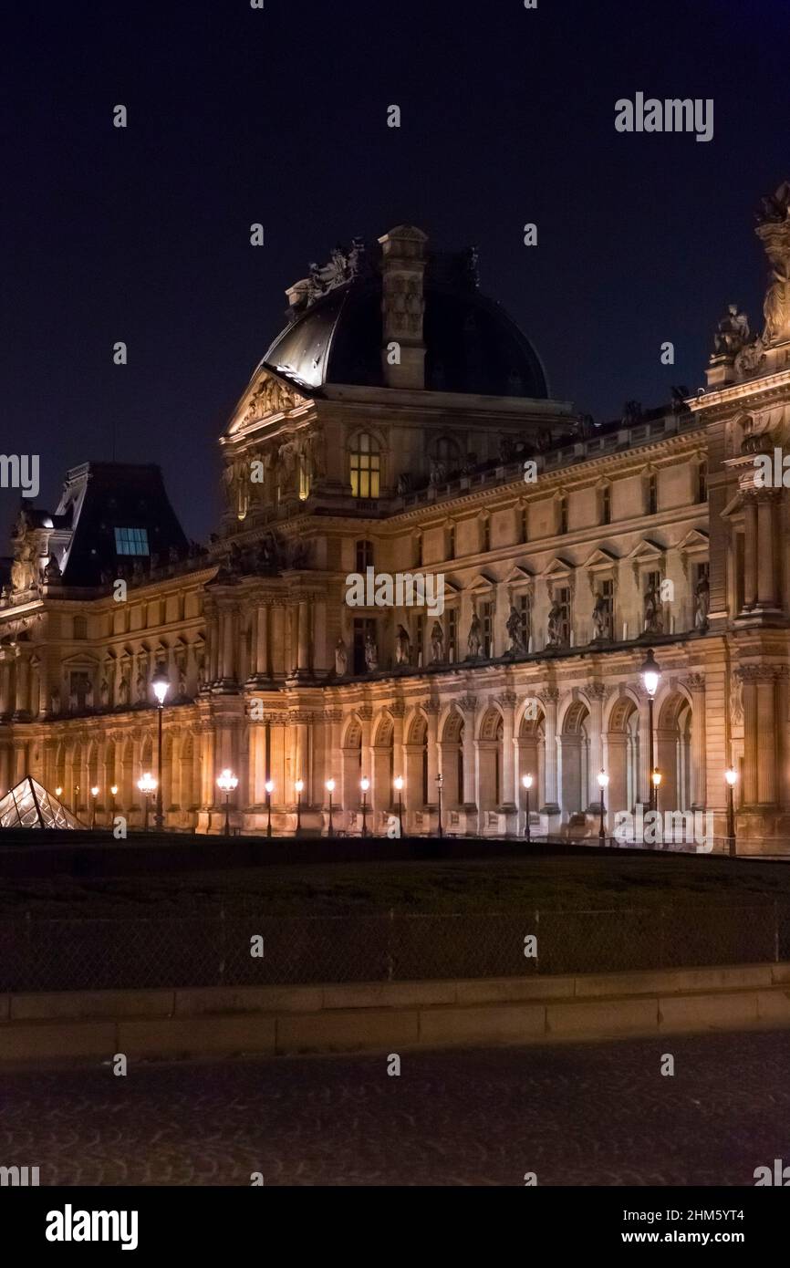 Paris, France - JAN 24, 2022: The glass pyramid of Louvre Museum, the main entrance to famous museum and gallery, completed in 1989. A beautiful winte Stock Photo