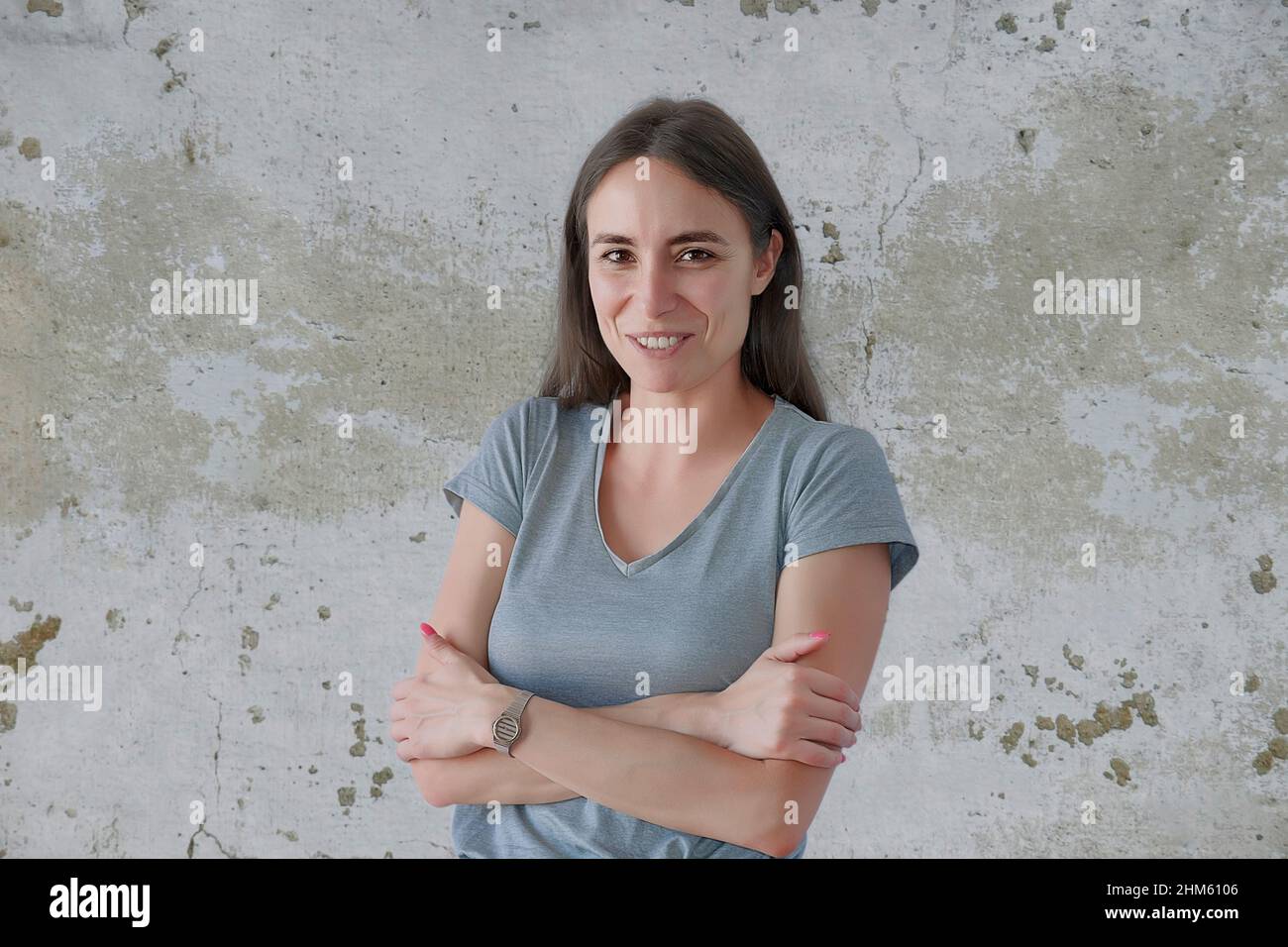 Portrait of smiling attractive young woman with crossed arms Stock ...