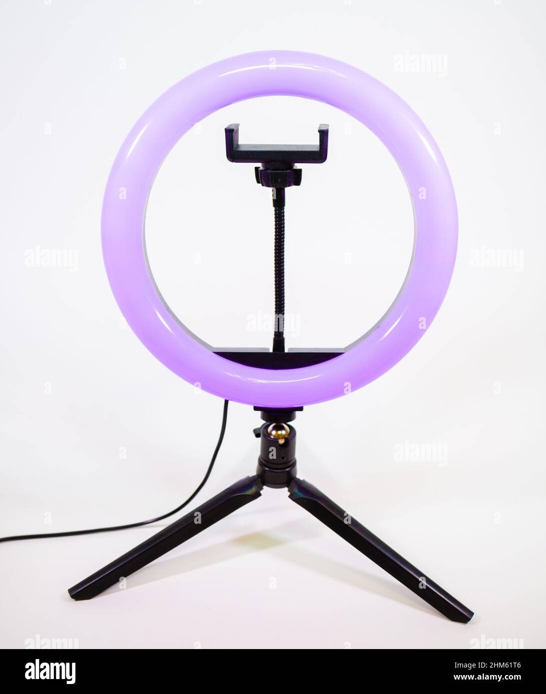 Ring lamp on a small tripod. Purple light. Stock Photo