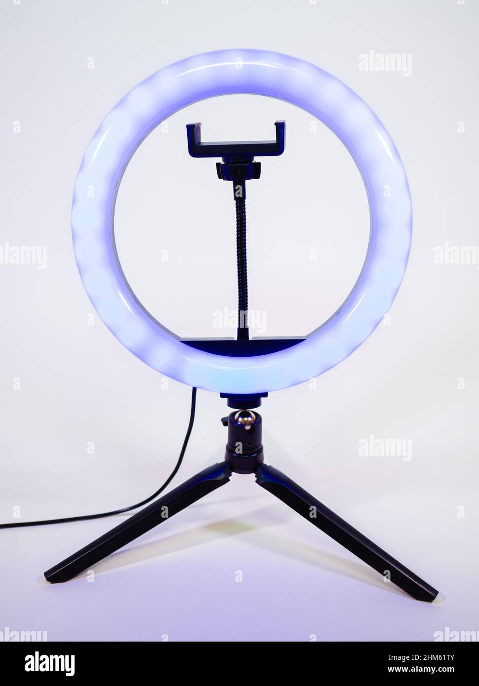 Ring lamp on a small tripod. Blue light. Stock Photo