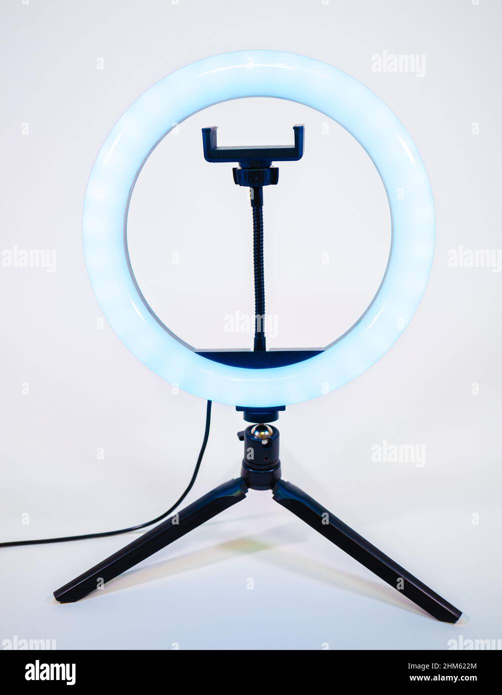 Ring lamp on a small tripod. Blue light. Stock Photo