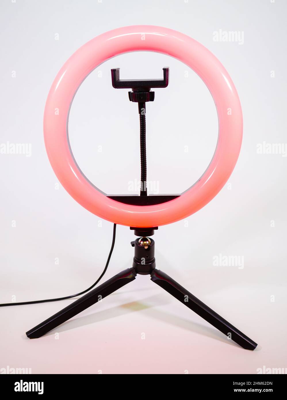 Ring lamp on a small tripod. Red light. Stock Photo