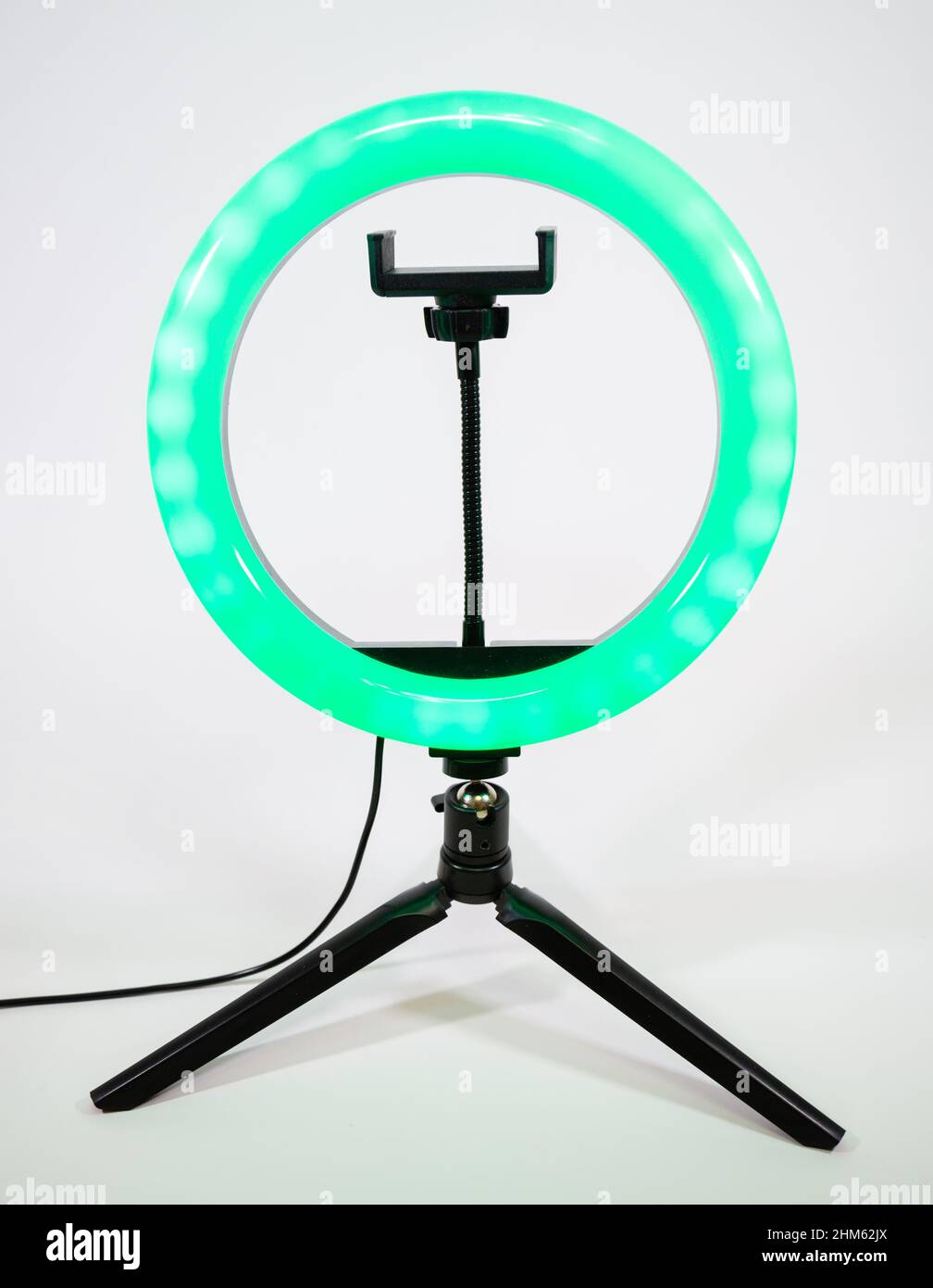 Ring lamp on a small tripod. Green light. Stock Photo