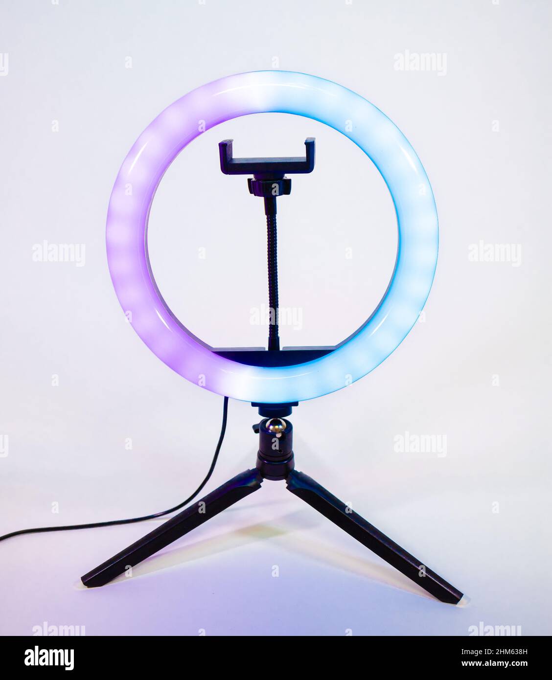 Ring lamp on a small tripod. Purple and blue light. Stock Photo