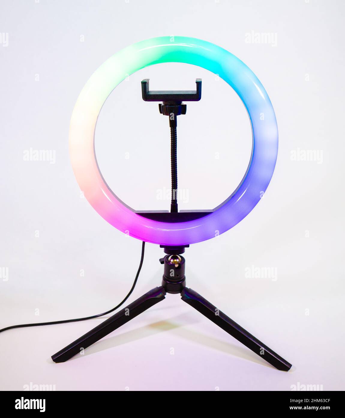 Ring lamp on a small tripod. Multicolored light. Stock Photo