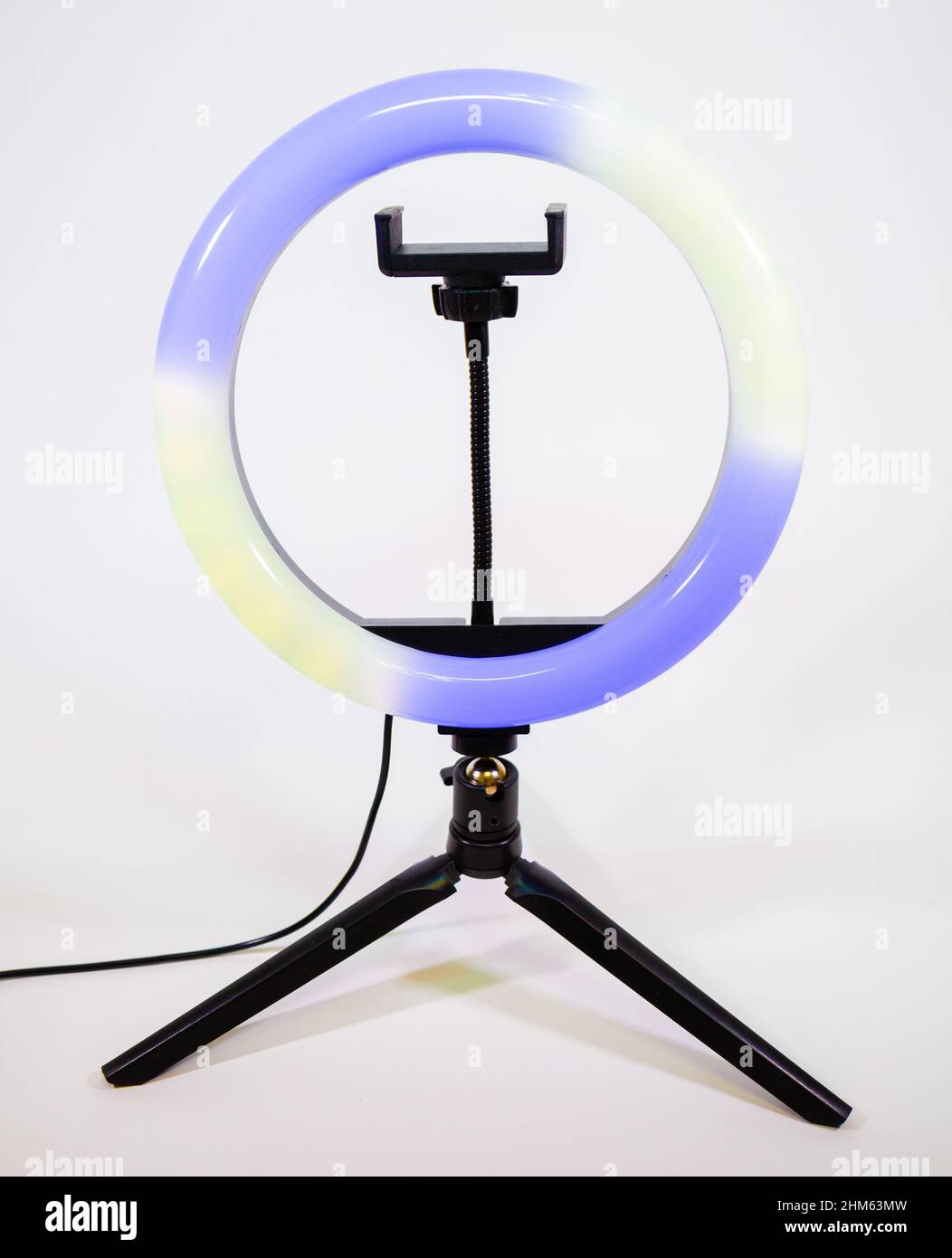 Ring lamp on a small tripod. Yellow and blue light. Stock Photo
